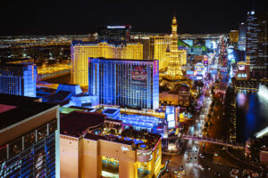 A stunning night view of the Las Vegas Strip, featuring iconic casinos like Bally’s and Paris Hotel, showcasing Nevada’s vibrant tours and cityscape.